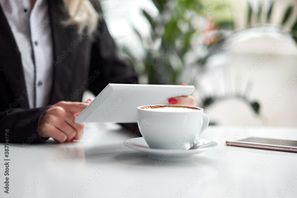 Business woman hands using smart phone and cup of coffee. Business woman hands using smart phone and cup of coffee.