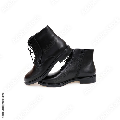 Fashionable black boots for men and women isolated on white background