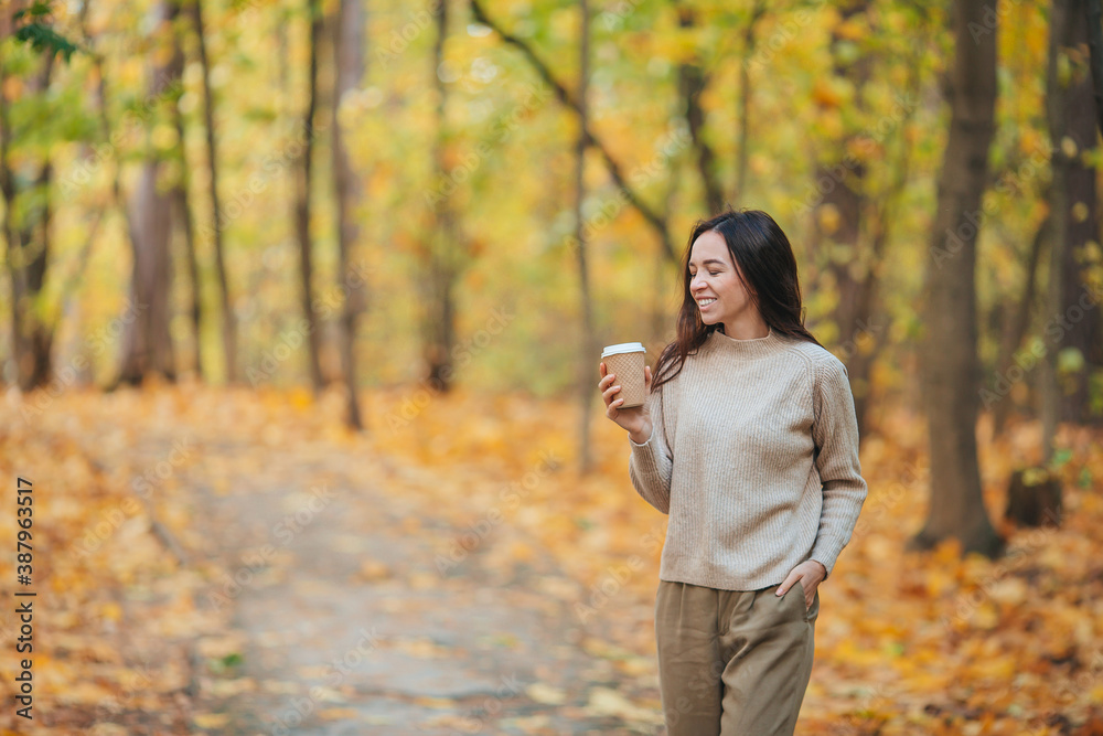 Fall concept - beautiful woman in autumn park under fall foliage Fall concept - beautiful woman in autumn park under fall foliage