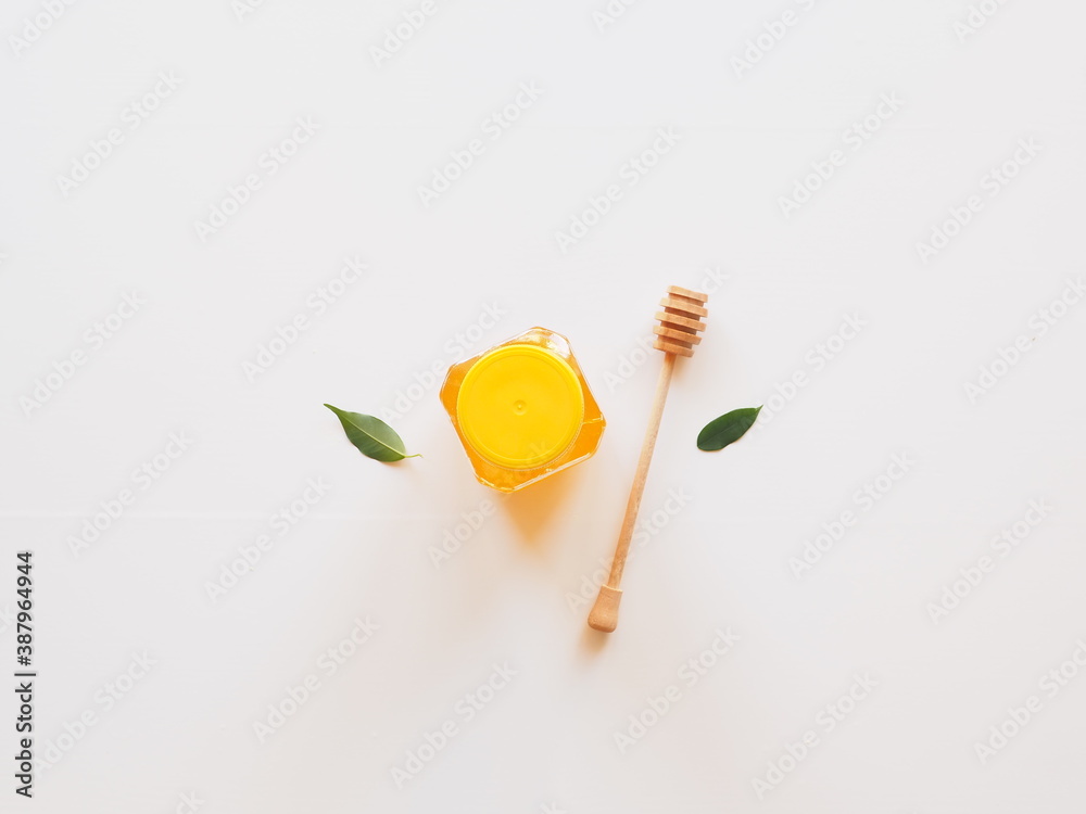Top view healthy honey with dipper and leaves isolated on white Top view healthy honey with dipper and leaves isolated on white