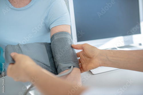 Close up picture of measuring blood-pressure to elderly woman