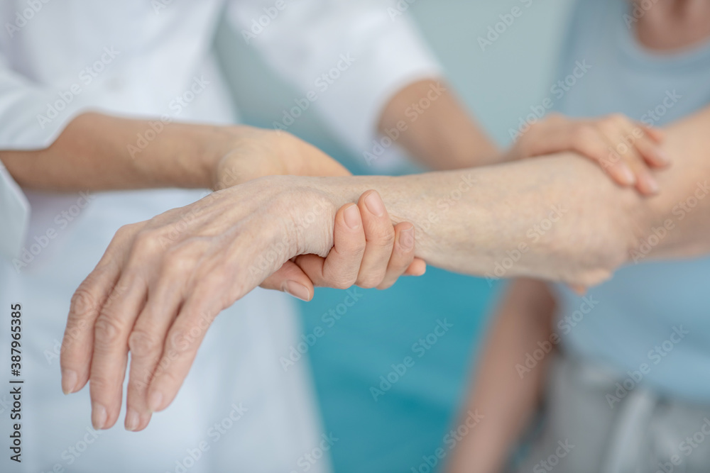 Close up of elderly womans wrist examining Close up of elderly womans wrist examining