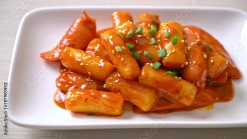 Korean rice cake stick with sausage in spicy sauce - Tteokbokki photo