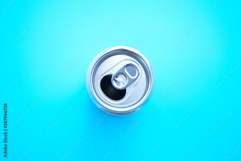 Flat lay of aluminum can opened on blue background Flat lay of aluminum can opened on blue background