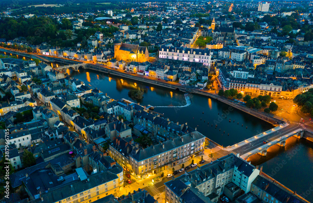Evening aerial view of Laval with buildings, river Mayenne and old bridge, Mayenne department, north-western France - obrazy, fototapety, plakaty 