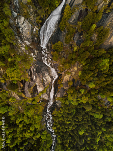 Aerial view of a majestic waterfall in Val di Mello, Lombardy, Italy.