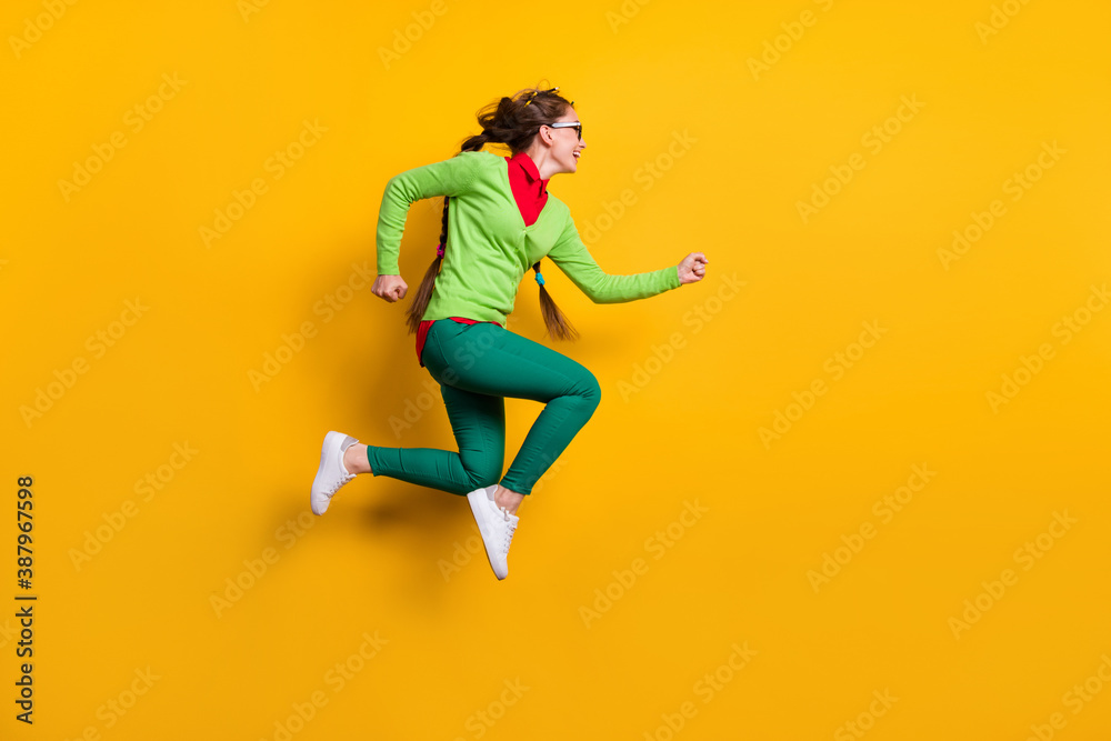 Full length body size profile side view of pretty funky energetic cheerful girl jumping running isolated bright yellow color background