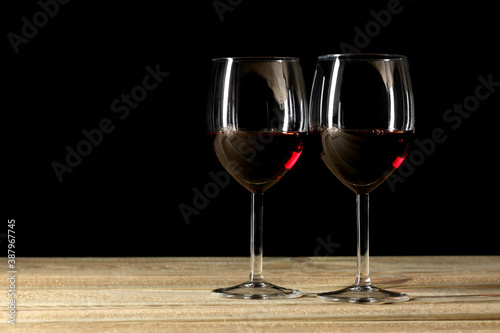 two red wine glasses on a wooden table with copy space for your text