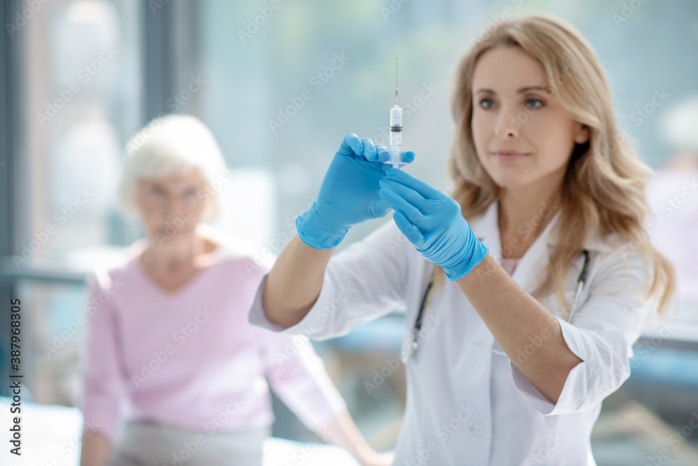 Cute female nurse holding an ampule with vaccine Stock Photo Adobe Stock