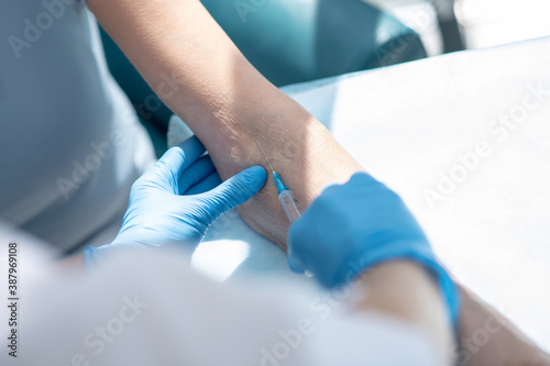 Close up picture of human hands making intravenous injection