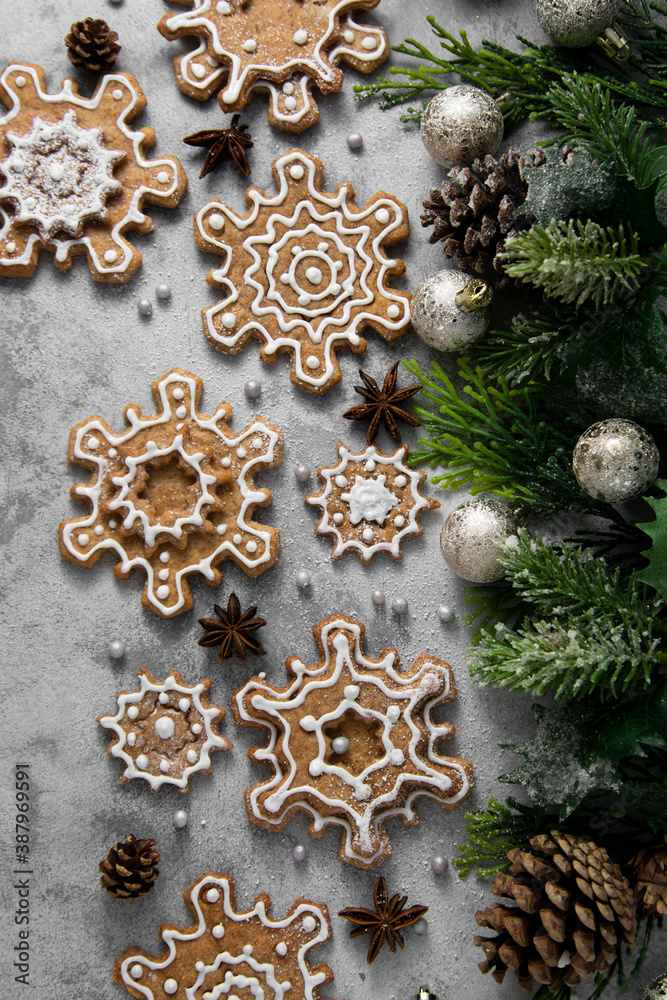 Gingerbread cookies, snowflakes shaped with icing, fir branch. Abstract Christmas food, cookies. Top view. Gingerbread cookies, snowflakes shaped with icing, fir branch. Abstract Christmas food, cookies. Top view.