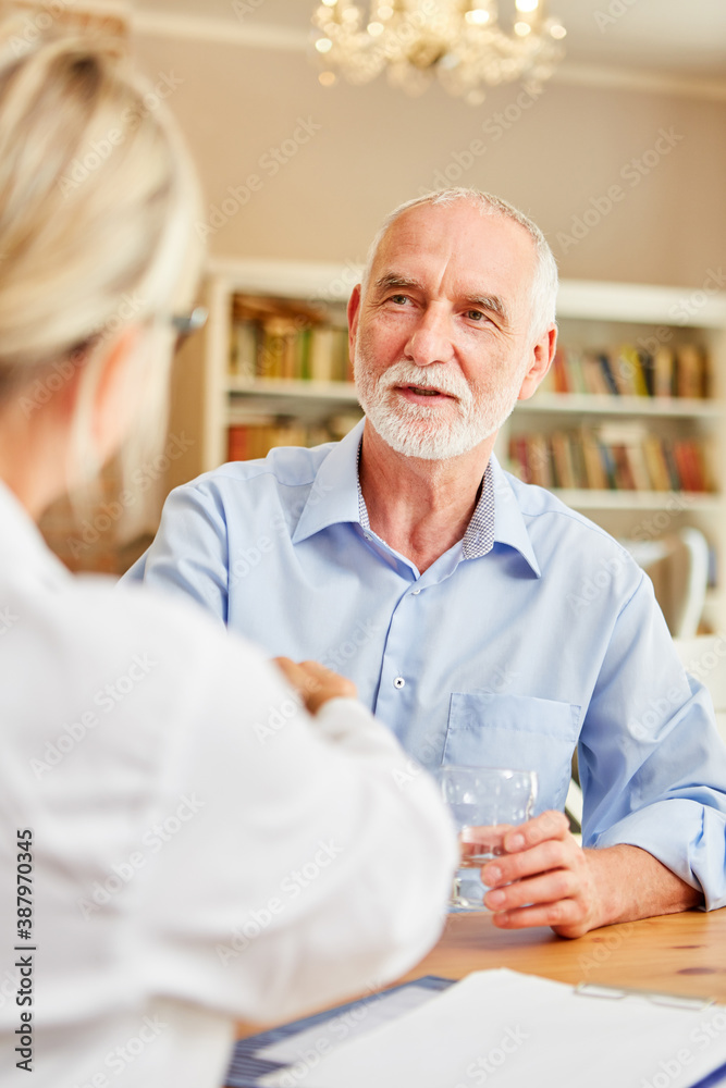 Female doctor welcomes senior man with handshake Female doctor welcomes senior man with handshake
