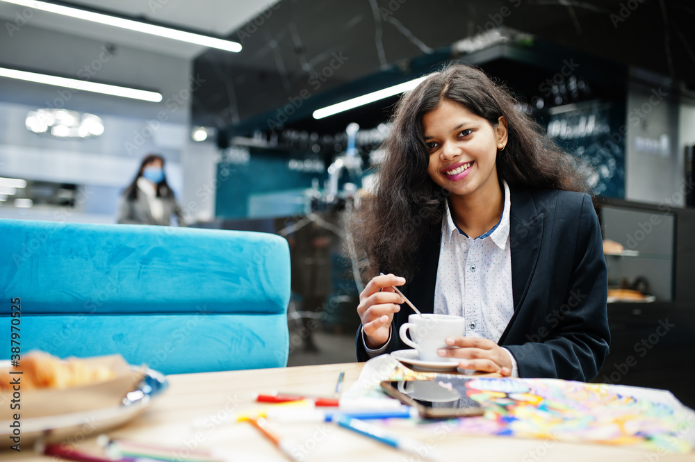 Indian artist woman wear formal paint picture and drink tea, while sitting at cafe. Indian artist woman wear formal paint picture and drink tea, while sitting at cafe.