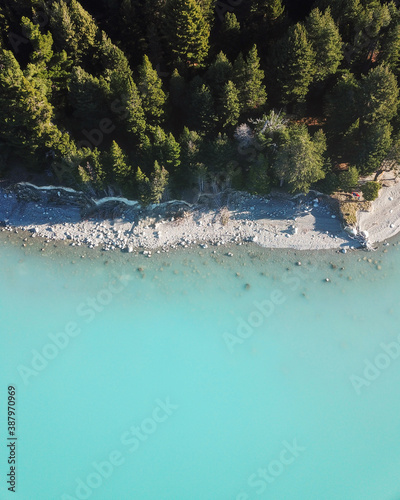 Aerial view of trees and blue water of Lake Pukaki, South Island, New Zealand