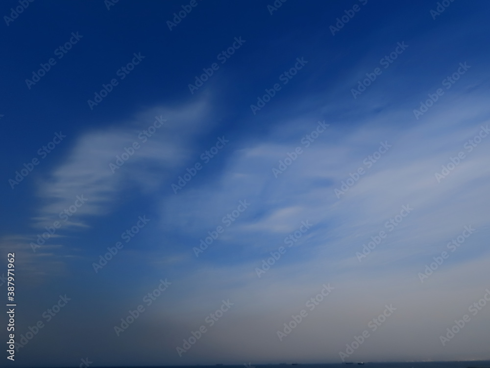Fototapeta premium Beautiful blue sky and white clouds over the mediterranean sea in autumn in Israel.
