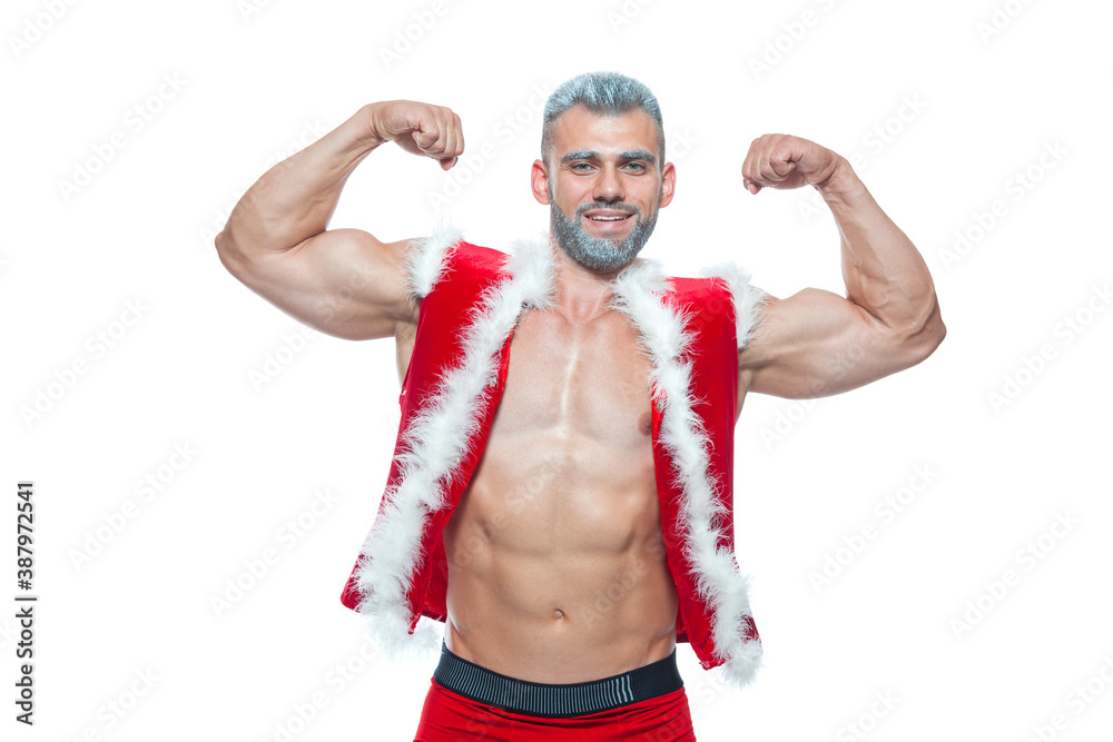 Sexy Santa Claus . Young muscular man wearing Santa Claus hat demonstrate his muscles. Isolated on white background.
