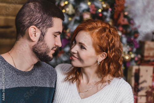 a young couple in love, a man and a red-haired woman celebrate the new year together. romantic Christmas