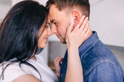 Fotografie Cute husband and wife tenderly embrace each other