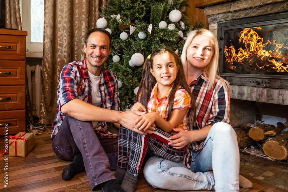 family and christmas tree in an old wooden house
