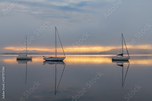 Misty Morning with Boats and Reflections on the Bay