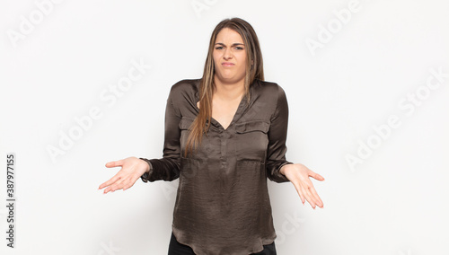 Fotografie young blonde woman feeling clueless and confused, not sure which choice or optio