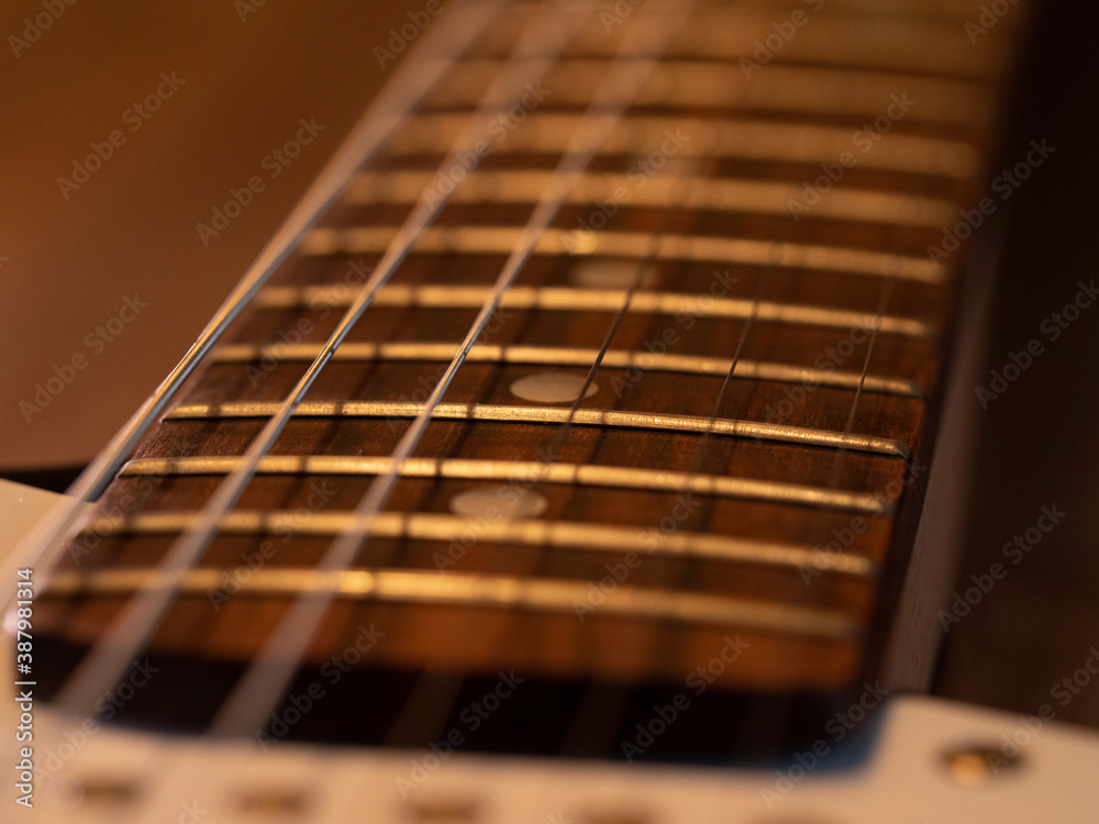 Detail of a black and white electric guitar Detail of a black and white electric guitar