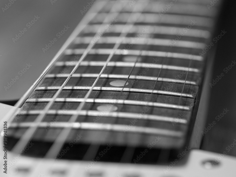 Detail of a black and white electric guitar Detail of a black and white electric guitar
