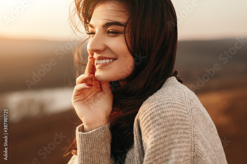 Happy young woman enjoying sunset in nature