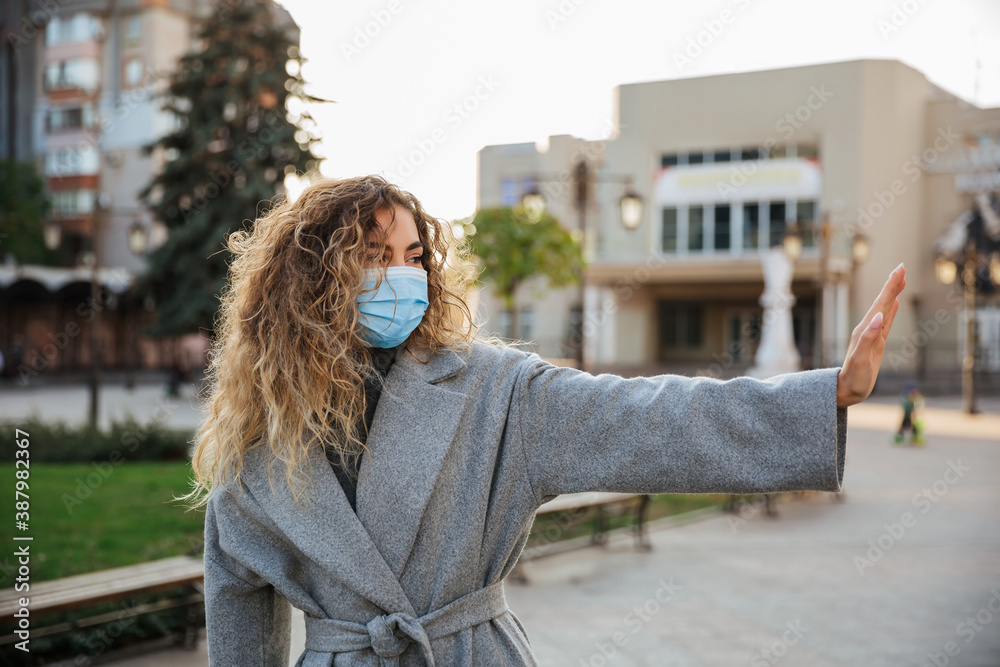 Keep your social distance. woman in virus protection face mask showing gesture Stop Infection. Coronavirus COVID-19 pandemic and healthcare concept. Keep your social distance. woman in virus protection face mask showing gesture Stop Infection. Coronavirus COVID-19 pandemic and healthcare concept.