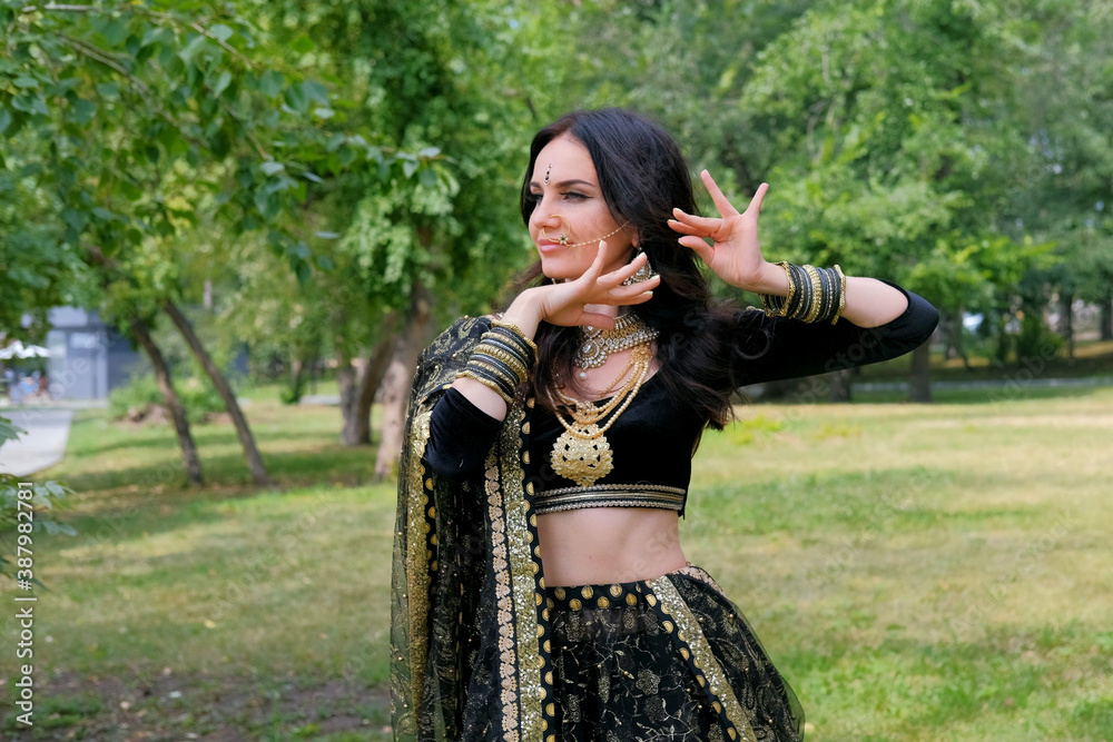 Woman in ethnic indian costume with jewellery and traditional makeup.