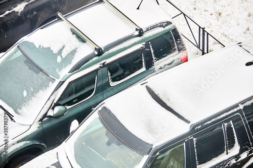 Cars covered with snow in winter in a parking lot © gesrey
