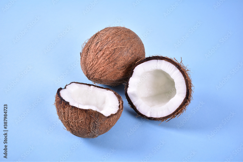 Coconut and one cracked on two on blue background