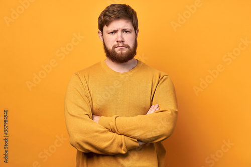 solution. a young cute man gets rid of the problem alone. Confident man with a beard. isolated yellow background