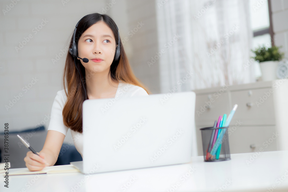 Young asian woman wearing headphone study online with e-learning on desk, girl wearing headset learning to internet with laptop computer at home, new normal, distance education and training. Young asian woman wearing headphone study online with e-learning on desk, girl wearing headset learning to internet with laptop computer at home, new normal, distance education and training.