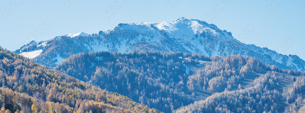Snow-capped peaks, autumn panoramic view