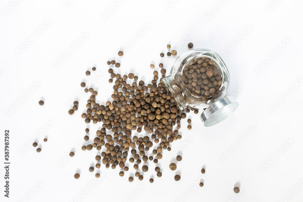 Black peppercorns on white table, flat lay Black peppercorns on white table, flat lay