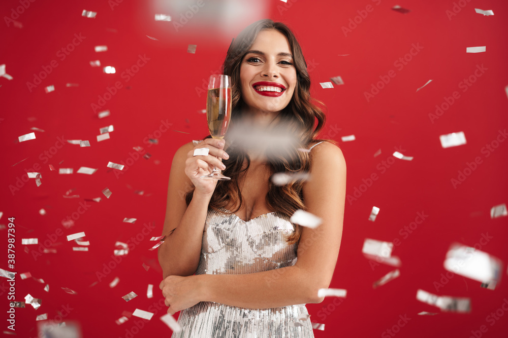 Charming happy girl in evening dress smiling and holding champagne glass Charming happy girl in evening dress smiling and holding champagne glass