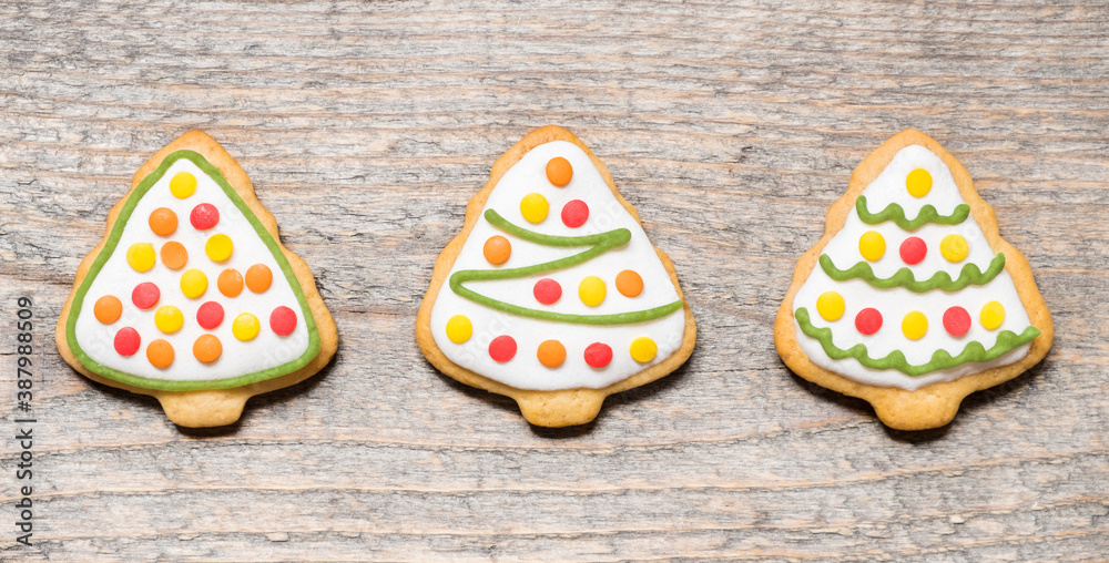 Christmas cookies in the form of trees on wooden background Christmas cookies in the form of trees on wooden background