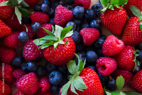 Fototapeta Naklejka Na Ścianę i Meble -  Fresh Strawberry, blueberry and raspberry.Colorful fresh forest fruits background.Healthy food concept.