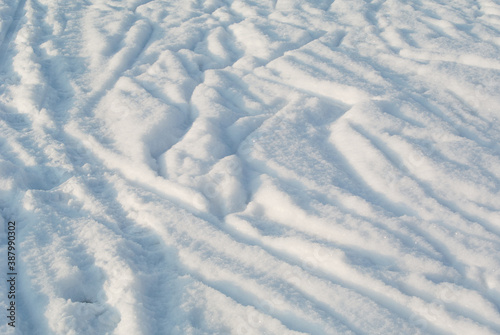 Surface of pure white snow with chaotic tracks