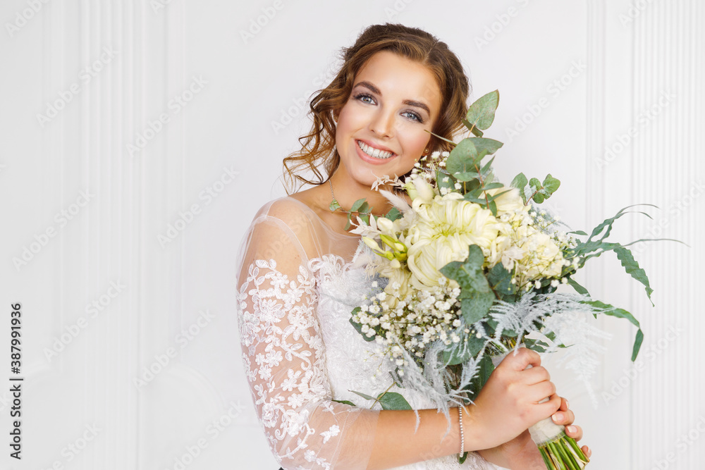 Beautiful young bride with wedding bouquet on light background Beautiful young bride with wedding bouquet on light background