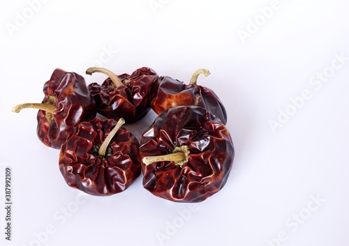 Spanish dried ñora nyora pepper on white background, artificial light, close up, top view photo