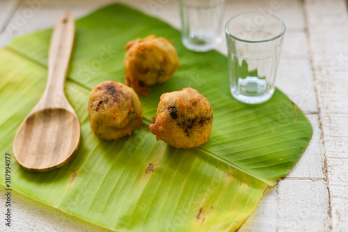 Sukhiyan or Sugiyan Kerala fried snacks sweet food on banana leaf  tea time food fried in coconut oil.  made with moong dal lentil. South Indian snacks. Kachori a spicy snack for Diwali photo