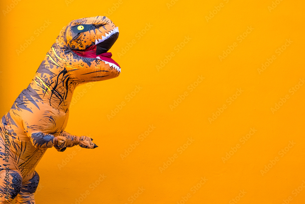 Fototapeta premium one big and tall dinosaur enjoying and having fun with orange background - copy and blank space to write your text here