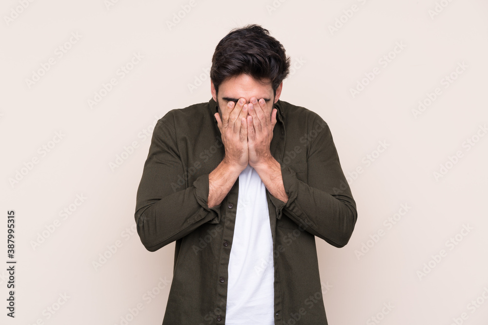 Young handsome man with beard over isolated background with tired and sick expression Young handsome man with beard over isolated background with tired and sick expression