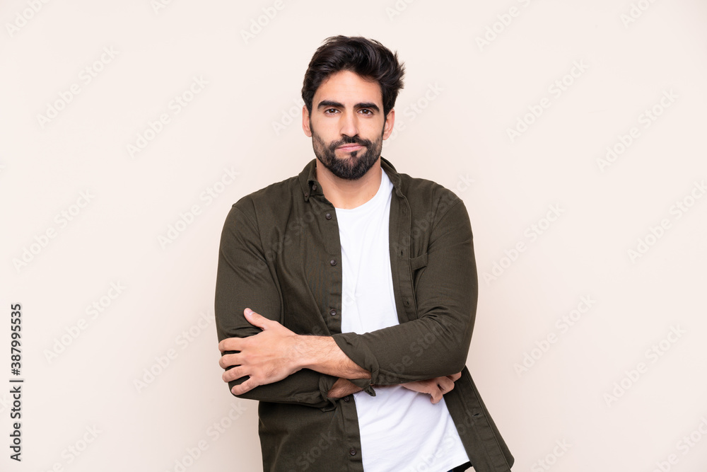 Fototapeta premium Young handsome man with beard over isolated background feeling upset