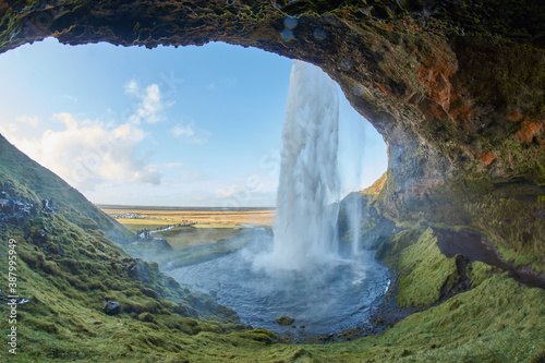 Beautiful waterfall in Iceland  Icelandic waterfall Seljalandsfoss  Photo shot from cave inside of waterfall