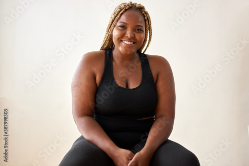 plump, plus size african american young woman in sportswear sit