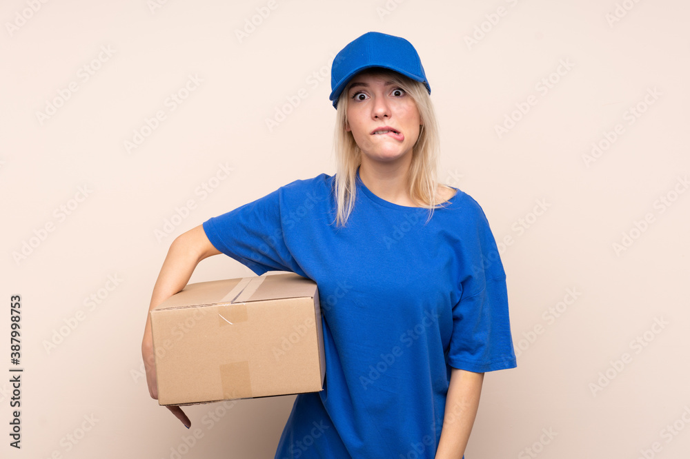 Young delivery woman over isolated background having doubts and with confuse face expression Young delivery woman over isolated background having doubts and with confuse face expression