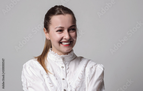 Portrait of young laughing woman in white shirt © martina87